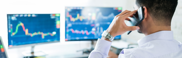 Financial markets professional reviewing trading screens